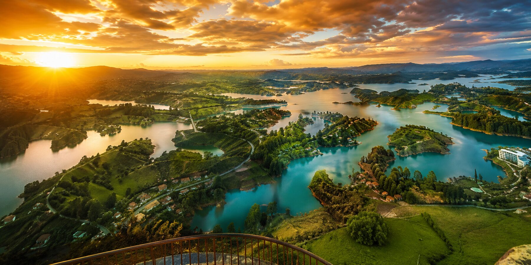 Stunning sunset view from the top of El Peñol Rock overlooking the Guatapé reservoir and green islands